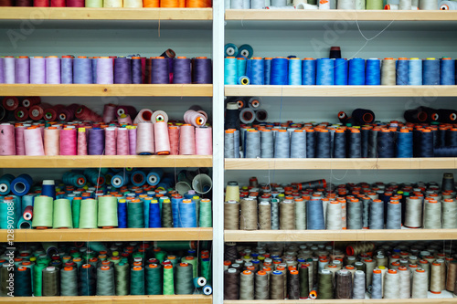 Colorful thread spools used in fabric industry © NDABCREATIVITY