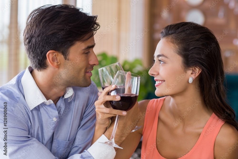 Couple toasting with arms crossed with a glass of wine Couple toasting with arms crossed with a glass of wine