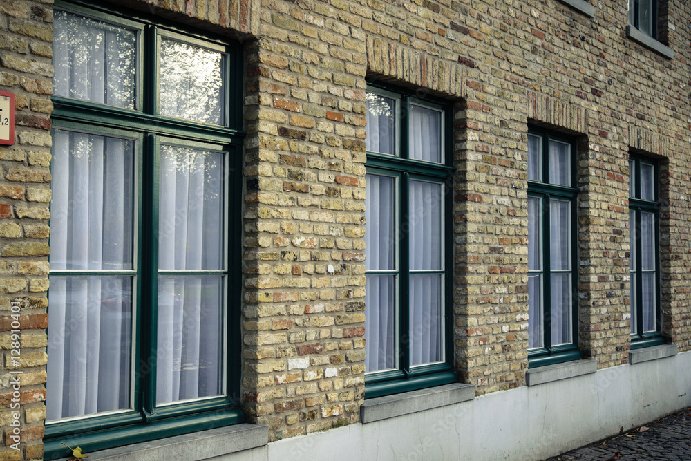 Brick wall with four windows in Bruges, Belgium Brick wall with four windows in Bruges, Belgium