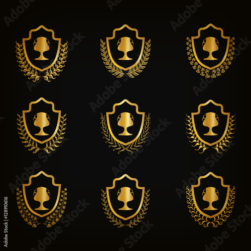 Set of luxury golden shields with laurel wreaths, champion cups. Filigree elements, award, emblem, icon, symbol, logo for web, page design Vector illustration EPS10