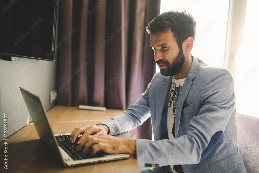 Handsome man working on laptop Handsome man working on laptop