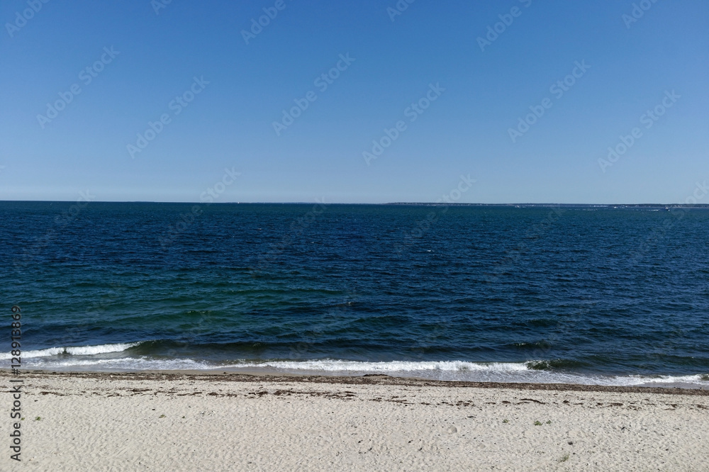 Sky, ocean, and beach seascape. Nobody. Horizontal.