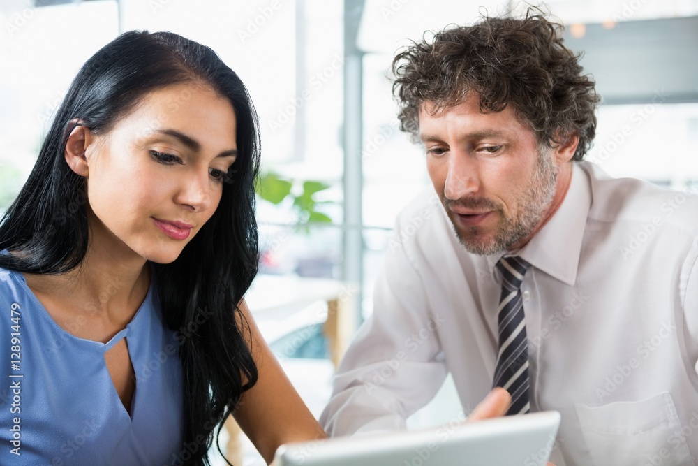 Businessman discussing with colleague over laptop Businessman discussing with colleague over laptop