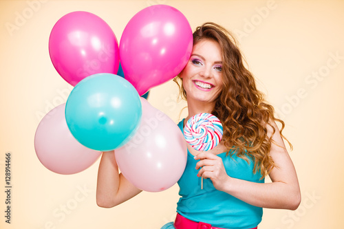 Woman with colorful balloons and lollipop © Voyagerix