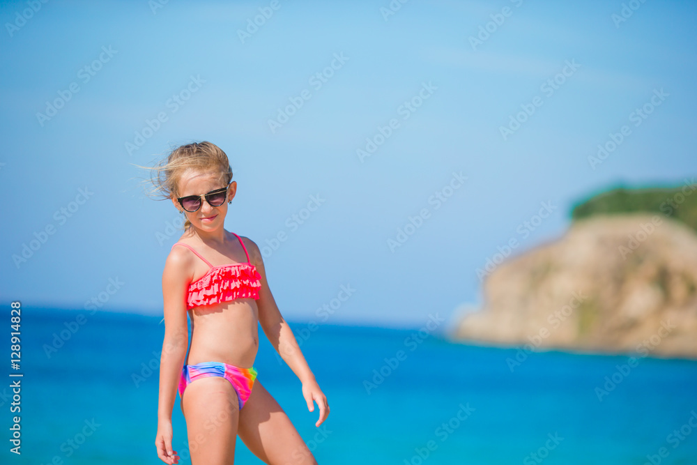 Adorable little girl have fun at tropical beach during vacation Adorable little girl have fun at tropical beach during vacation