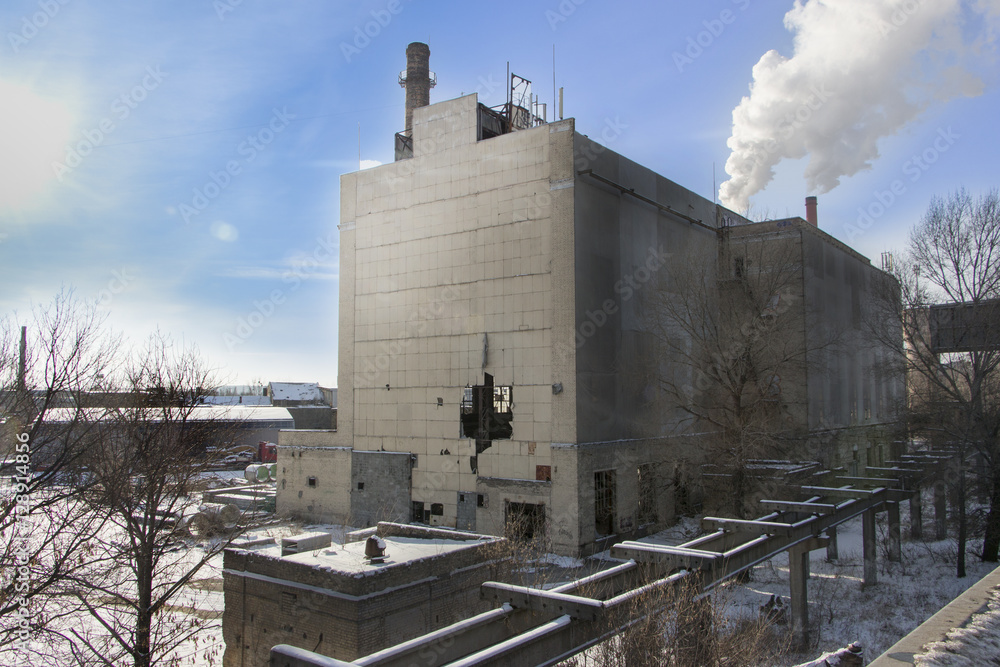 Obraz premium derelict industrial building with a hole in the wall