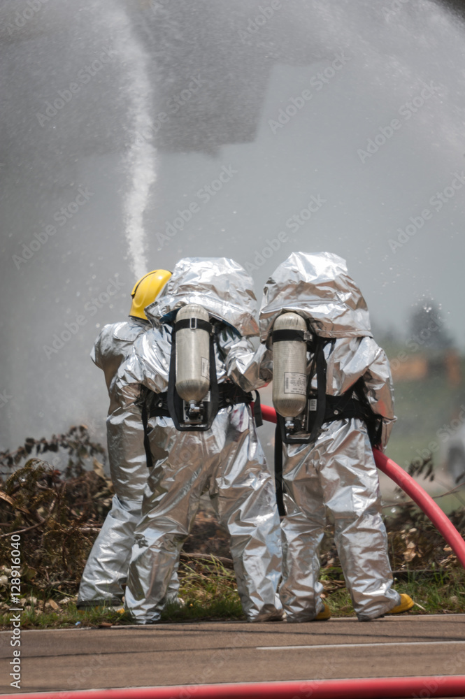 Obraz premium Fire departments & emergency response teams suited up with PPE t