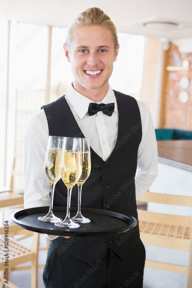 Portrait of waiter holding glasses of champagne Portrait of waiter holding glasses of champagne