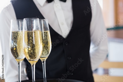 Waiter holding glasses of champagne