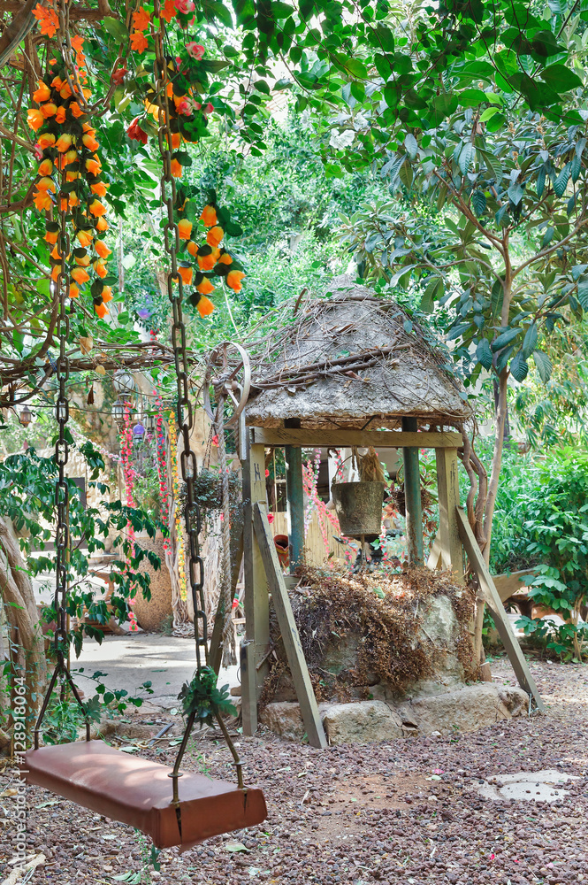  swings and an old well with a bucket