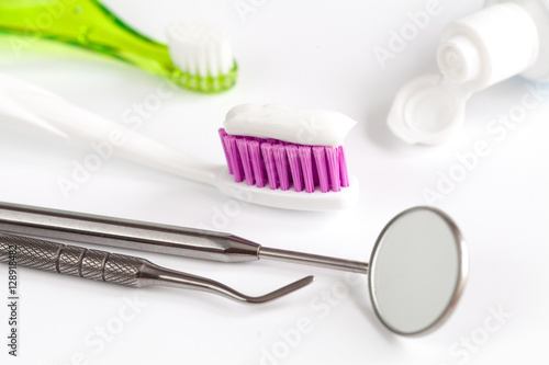 dental care toothbrush with dentist tools on white background