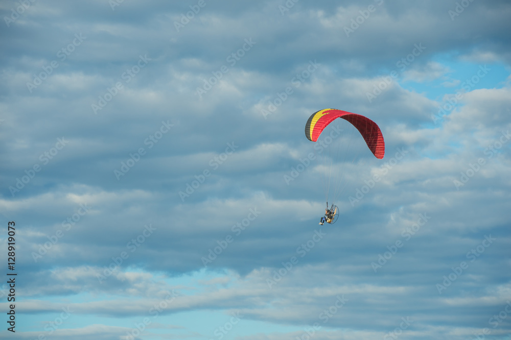 Paramotor flying over the fields in the sky. Paramotor flying over the fields in the sky.