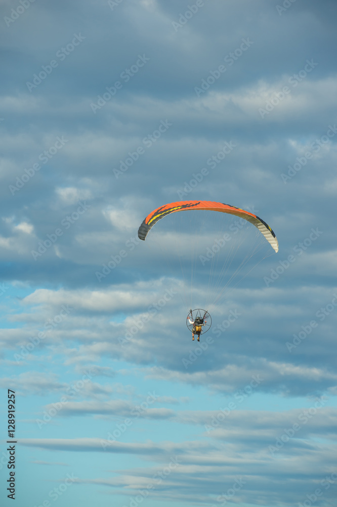 Paramotor flying over the fields in the sky. Paramotor flying over the fields in the sky.