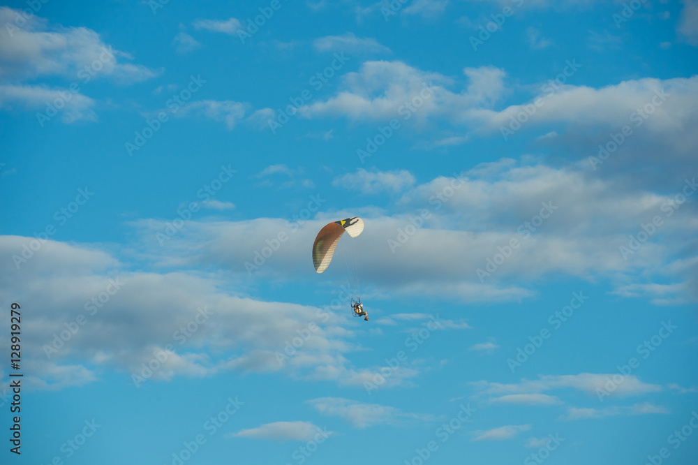 Paramotor flying over the fields in the sky. Paramotor flying over the fields in the sky.
