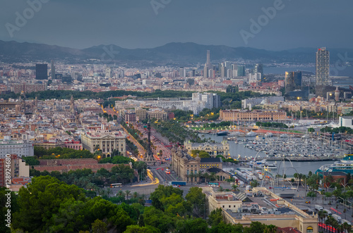 Early evening with illumination in Barcelona port and Columbus statue, Spain