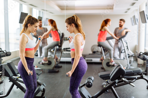 Beautiful woman wokring out in gym