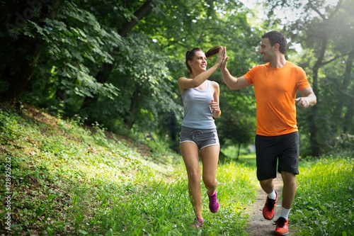 Fototapeta Naklejka Na Ścianę i Meble -  Healthy fit couple running in nature