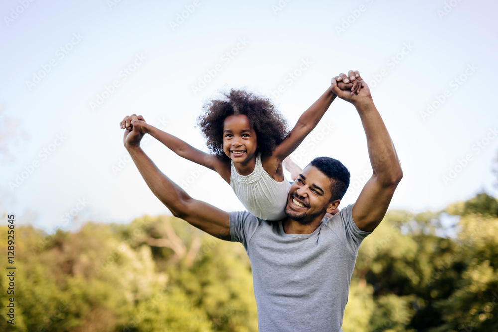 Father carrying daughter piggyback - obrazy, fototapety, plakaty 