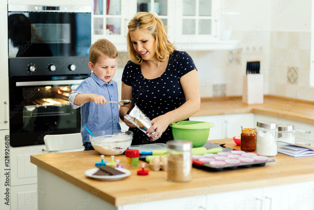 Mother and child preparing cookies Mother and child preparing cookies