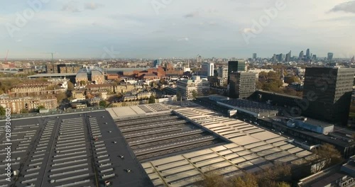 Aerial push out view over Euston station with the skyline of the City of London in the background photo
