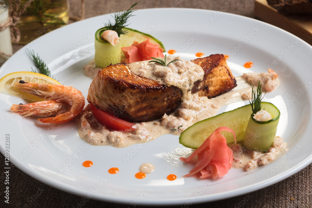 Concept: restaurant menus, healthy eating, homemade, gourmands, gluttony. Grilled salmon with shrimp and cream sauce with ingredients and vintage cutlery on sackcloth background. Concept: restaurant menus, healthy eating, homemade, gourmands, gluttony. Grilled salmon with shrimp and cream sauce with ingredients and vintage cutlery on sackcloth background.