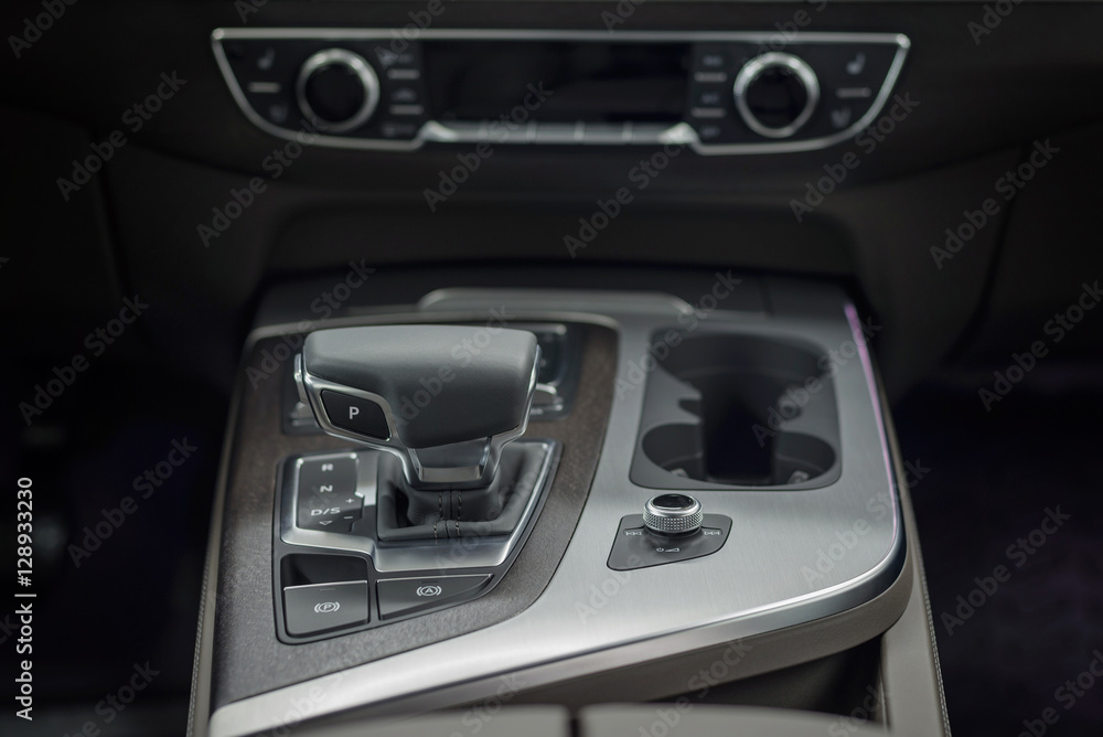 Naklejka premium Detail of new modern car interior. Focus on shift lever.