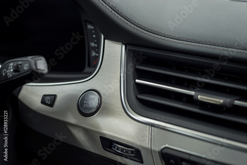 Engine start stop button. Modern car interior detail.