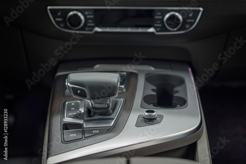 Detail of new modern car interior. Focus on shift lever. © alexdemeshko