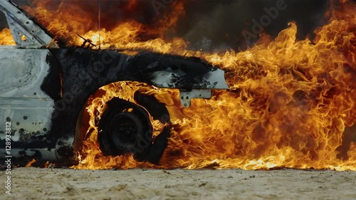 Pan around car on fire. photo