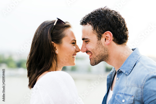 Young beautiful couple rubbing noses as a sign of love photo