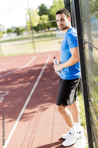 Young athlete taking a break on a hot summer day © NDABCREATIVITY