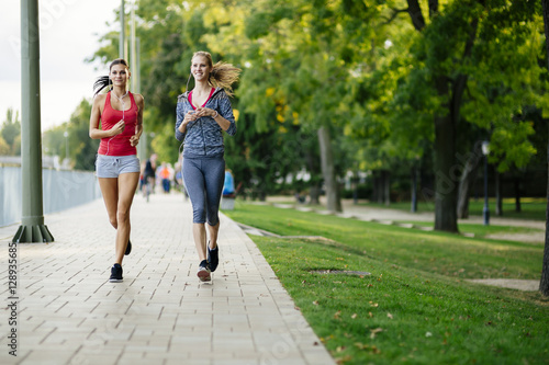 Two women jogging in park