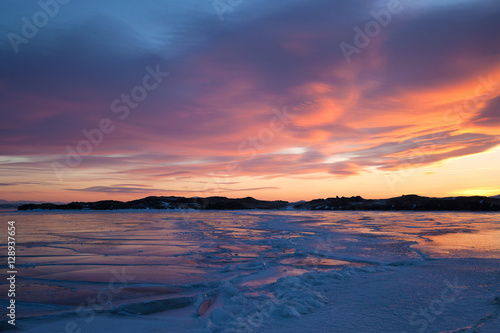 Winter landscape with color ice, sunset