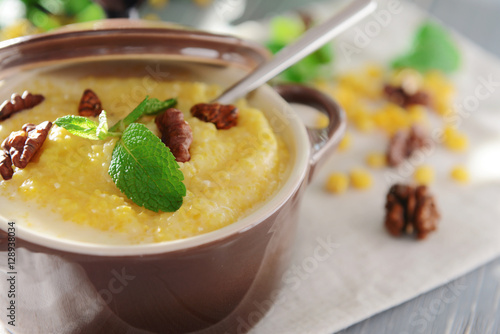 Delicious cornmeal porridge with walnuts and mint, closeup