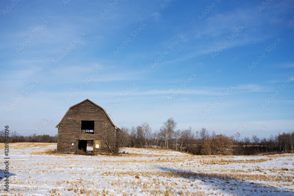 An abandoned barn and hayloft in an agricultural rural winter landscape An abandoned barn and hayloft in an agricultural rural winter landscape