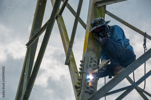 Welder work at high Electric high voltage pole 230 Kv