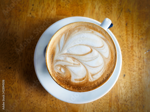 Flat White, a cup of coffee on wooden background