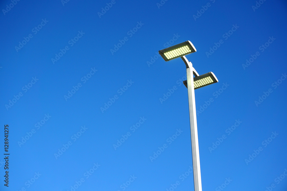 LED street lamp against blue sky