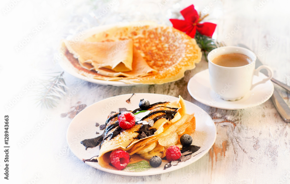 Christmas breakfast. Cup of Coffee and Crepes with fresh berries Christmas breakfast. Cup of Coffee and Crepes with fresh berries