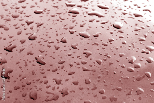 Rain drops on brown metal surface with blur effect