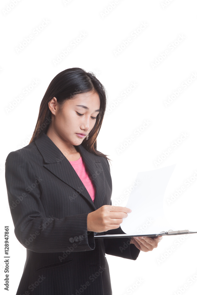 Young Asian business woman read paper on clipboard isolated on white background Young Asian business woman read paper on clipboard isolated on white background