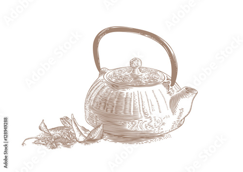 Iron teapot with tea leaves