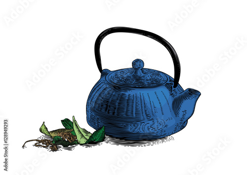 Iron teapot with tea leaves