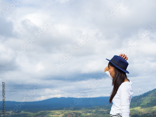 Back view of trendy girl in stylish with beautiful hat enjoying journey in mountains. © max_play