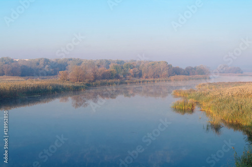 River landscape and autumn wood