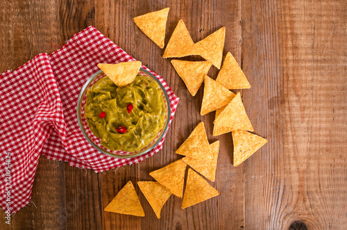 Guacamole dip and nacho chips.