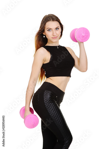 pretty girl in a black tracksuit with pink dumbbells on a white background © Evgeniy Kalinovskiy