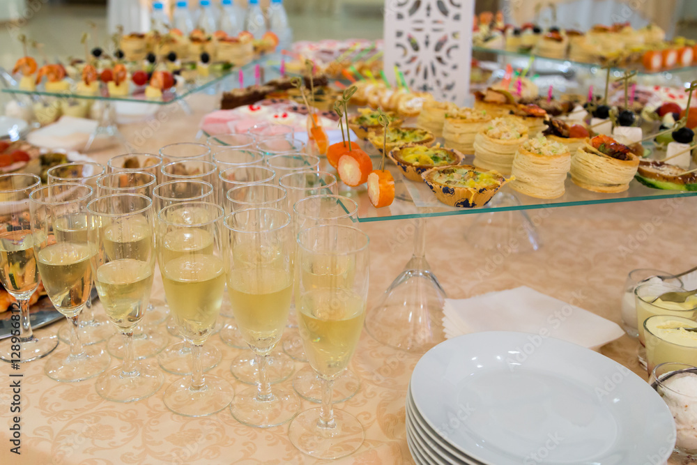 Banquet table with snacks, delicacies, beverages and desserts. On-site service. Catering