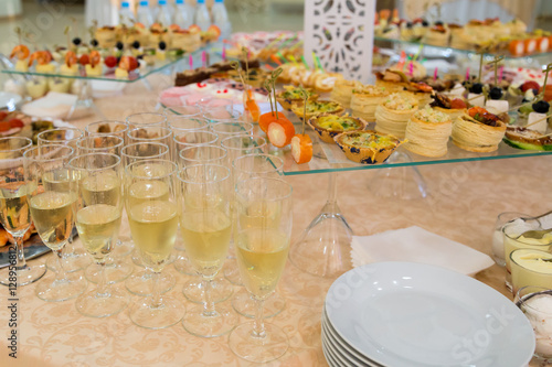 Banquet table with snacks, delicacies, beverages and desserts. On-site service. Catering