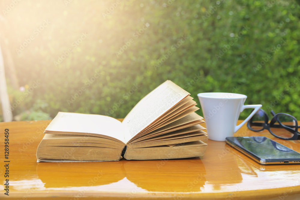 Naklejka premium Stock Photo:.Composition with books and cup of coffee on the tab